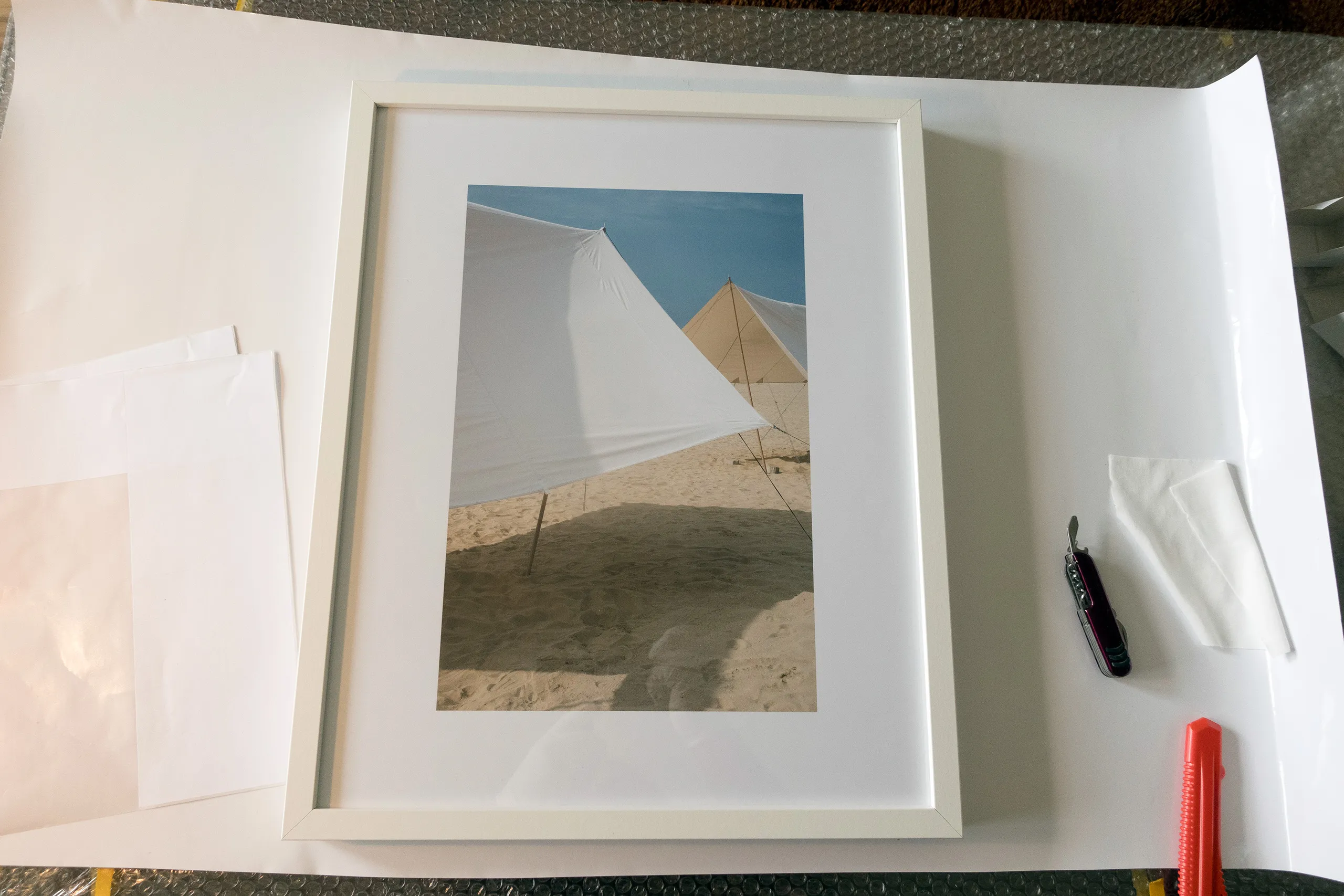 Citramarine — installation in progress, framing prints, RANDOM Gallery 2024