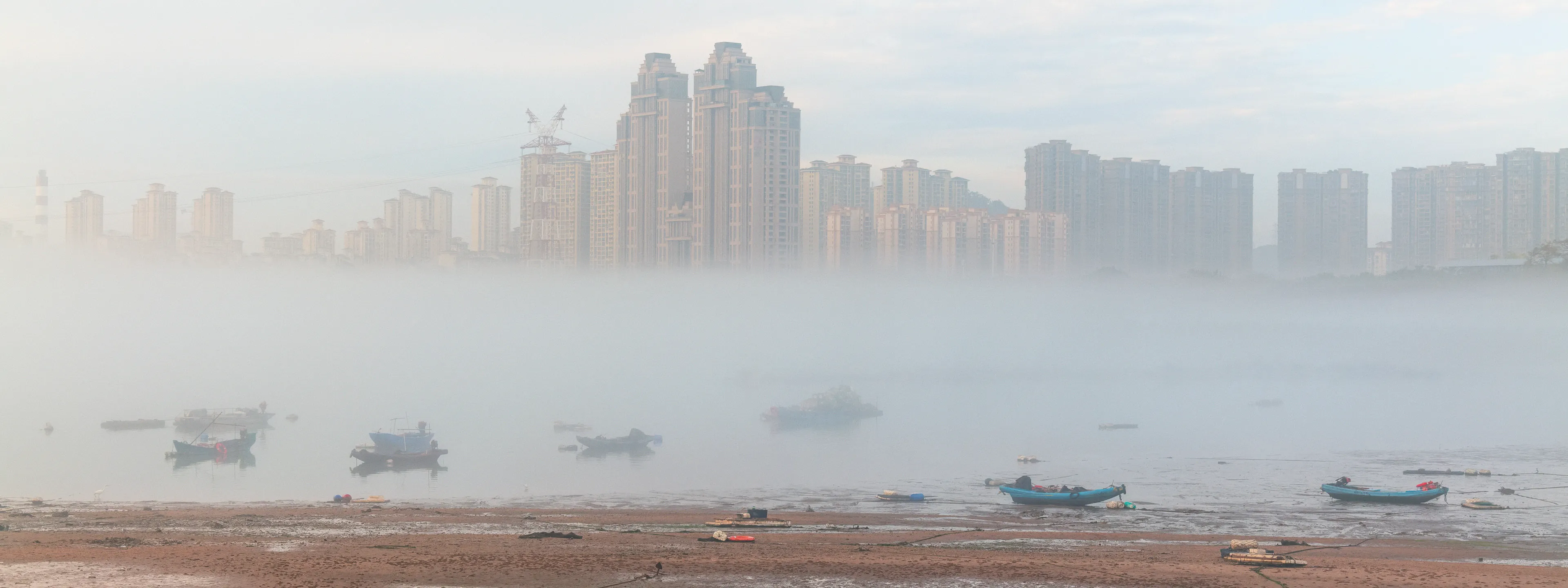 The Strip: On Temporary Grounds — tidal flats under a bridge in Xiamen, photograph by Andras Ikladi