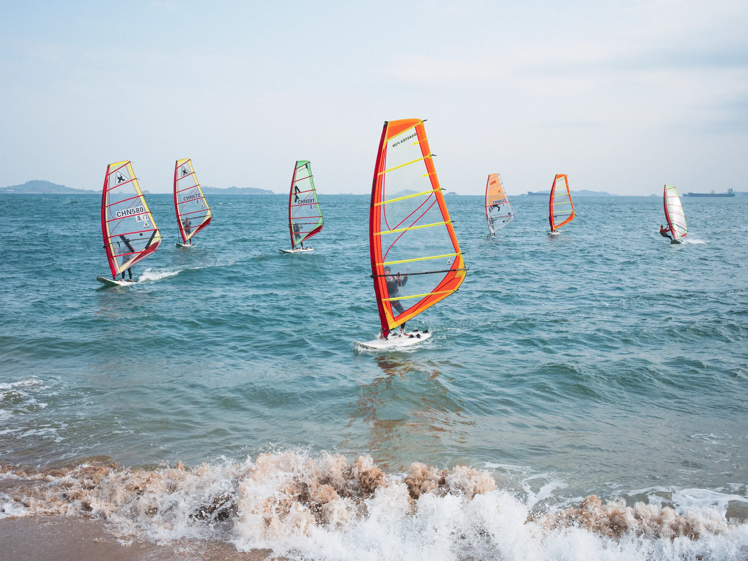 The Strip: Staying Afloat — swimming in the sea off Xiamen beach, photograph by Andras Ikladi