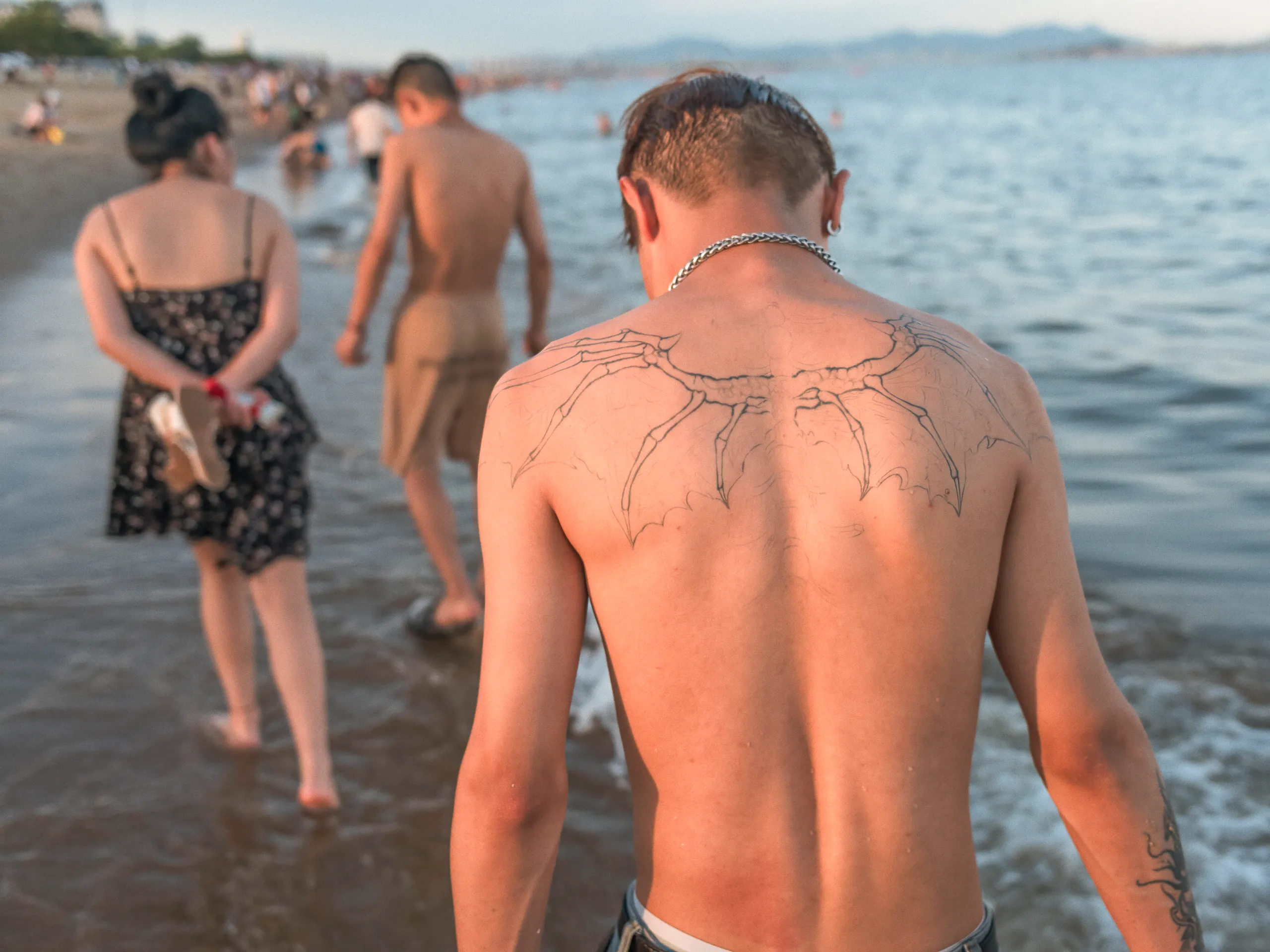 The Strip: Staying Afloat — swimming in the sea off Xiamen beach, photograph by Andras Ikladi