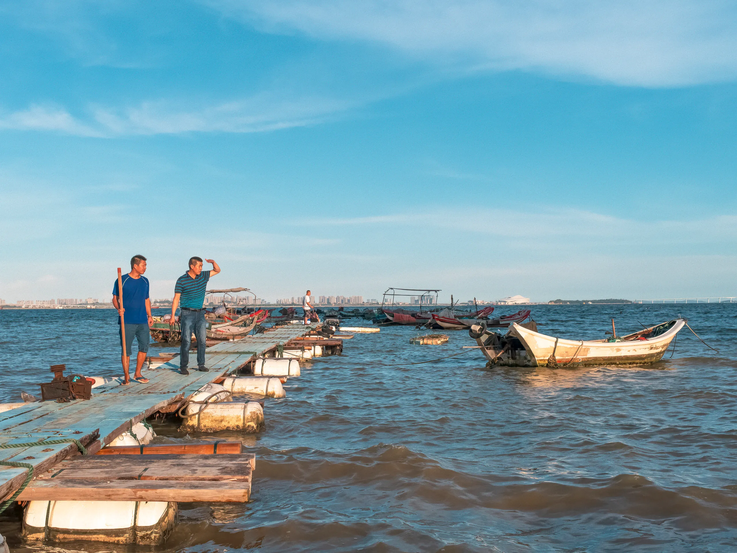 The Strip: Staying Afloat — swimming in the sea off Xiamen beach, photograph by Andras Ikladi